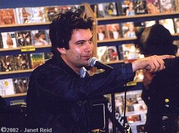 Guitarist Marko 72 checks out the store's selection while Pagnotta talks to the crowd. copyright Janet Reid